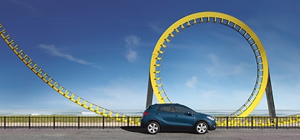 car passing rollercoaster