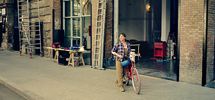 A woman carrying a bicycle