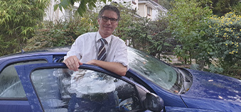 Man standing by his car