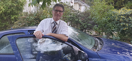 Man standing by his car