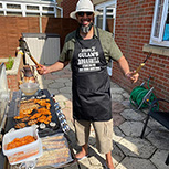 man standing by his grill