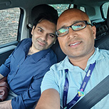 men smiling in a car selfie