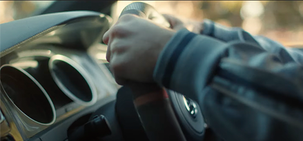 Person with hands on steering wheel